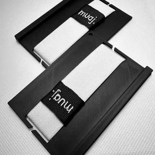 Two black cardholders with a white elastic band featuring the brand 'muaj.' on a white background